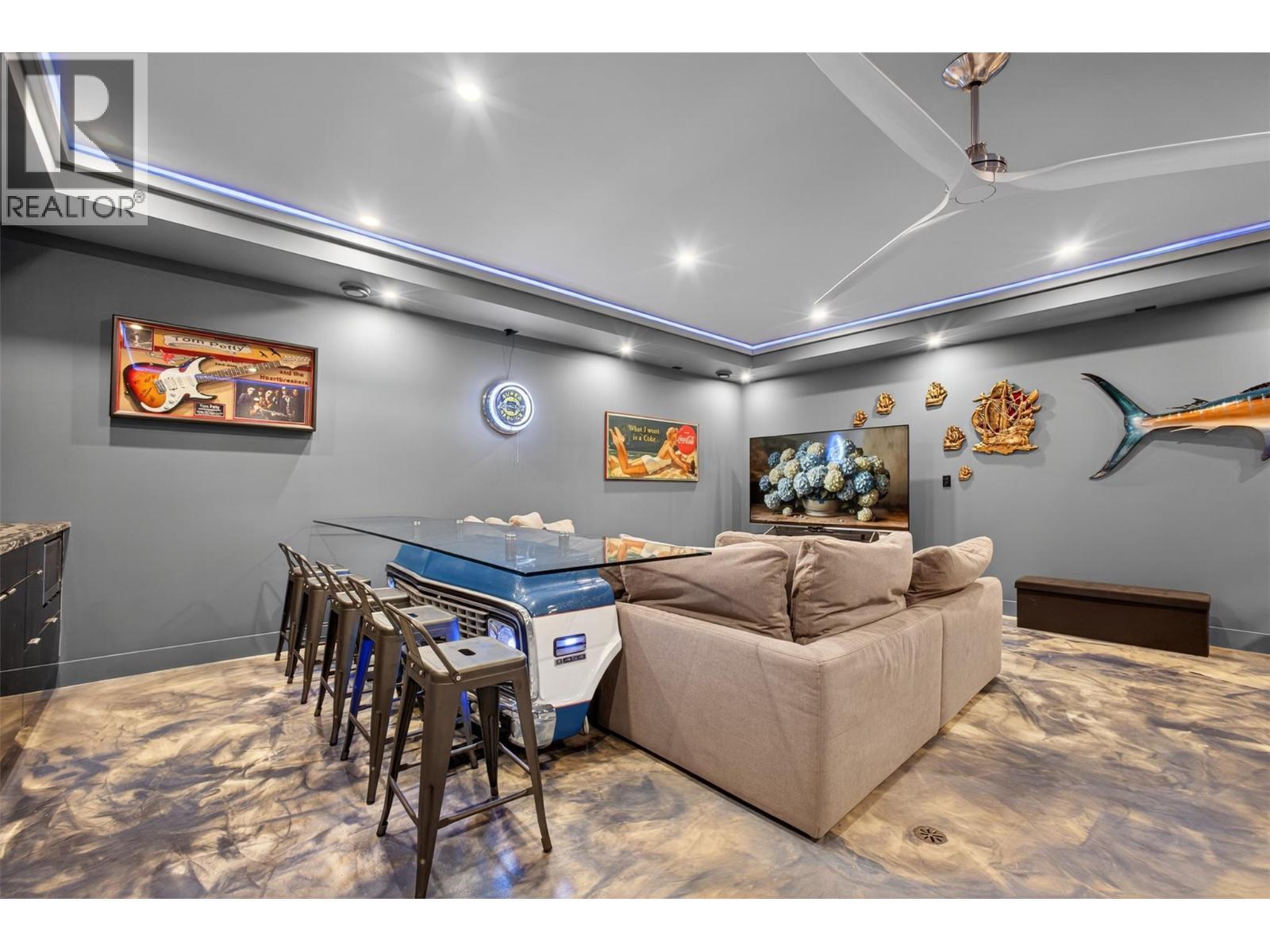 The lower level also includes a beautifully designed media and entertainment room located beneath the garage, creating a naturally quiet atmosphere ideal for movies, sports, or entertaining guests. - 5835 Vicary Road, Peachland, BC