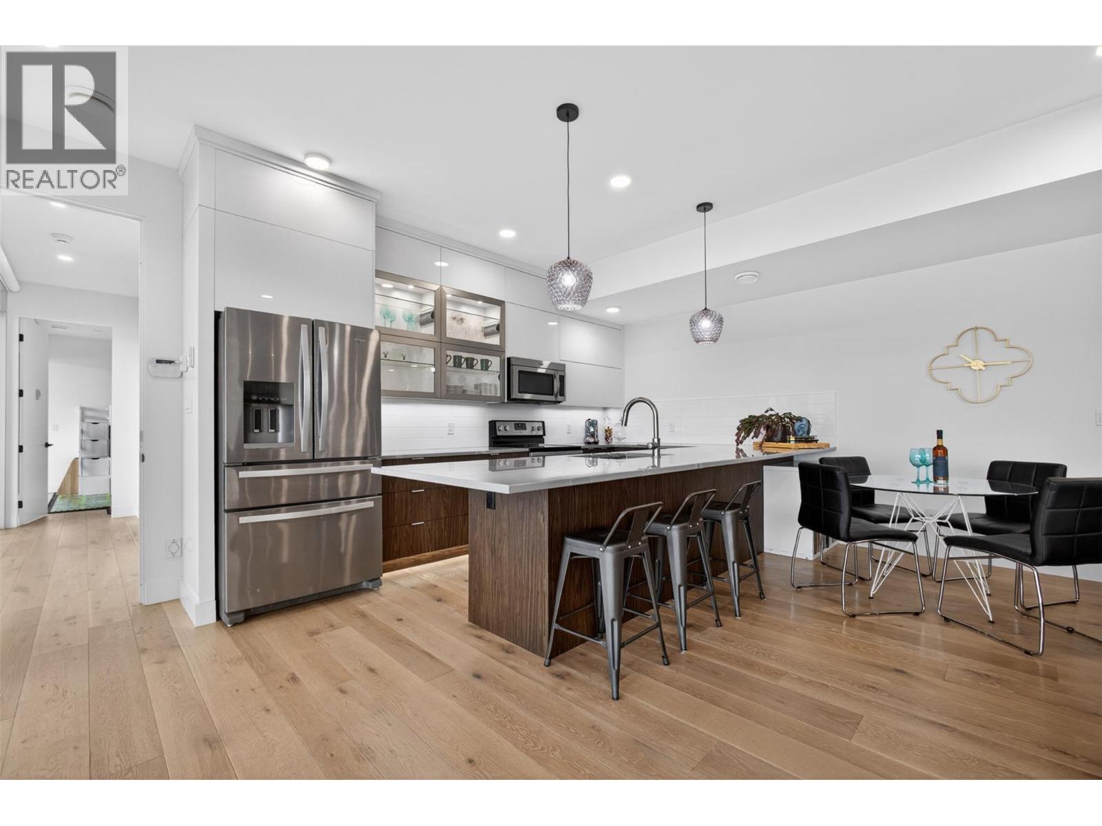 The suite includes a spacious bedroom, full living room, large kitchen, dedicated washer and dryer, office space, and a massive 15.5 ft. x 3.5 ft. Cambria quartz island. - 5835 Vicary Road, Peachland, BC