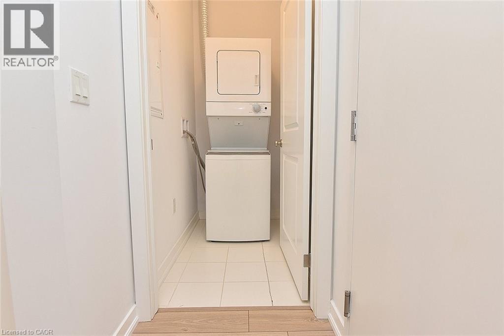 Stackable washer and dryer unit with a tiled floor - 4040 Upper Middle Road Unit# 105, Burlington, ON