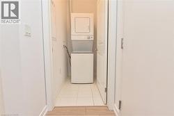 Stackable washer and dryer unit with a tiled floor -