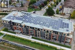 Contemporary multi-story building featuring extensive rooftop solar panel arrays -