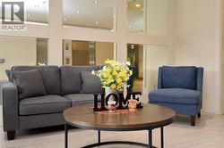 Lobby area featuring light-toned walls with rectangular mirror accents and recessed lighting -