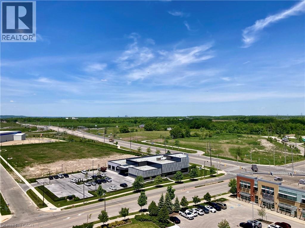 Expansive urban landscape featuring commercial structures, paved roadways, and undeveloped green spaces - 4878 Powers Common Unit# C-1105, Burlington, ON