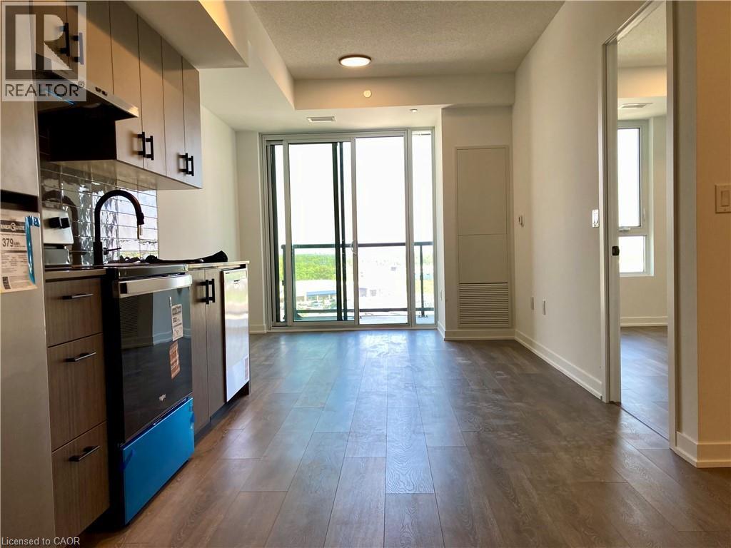 Open-concept living space with wood-finish flooring - 4878 Powers Common Unit# C-1105, Burlington, ON