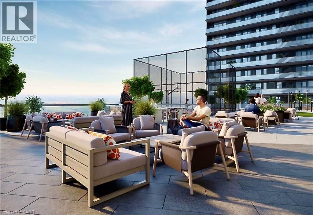 Expansive rooftop terrace with a paved surface, multiple seating areas, a sports court with fencing, and a glass-paneled barrier - 4878 Powers Common Unit# C-1105, Burlington, ON