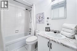White tiled shower and bathtub combination -