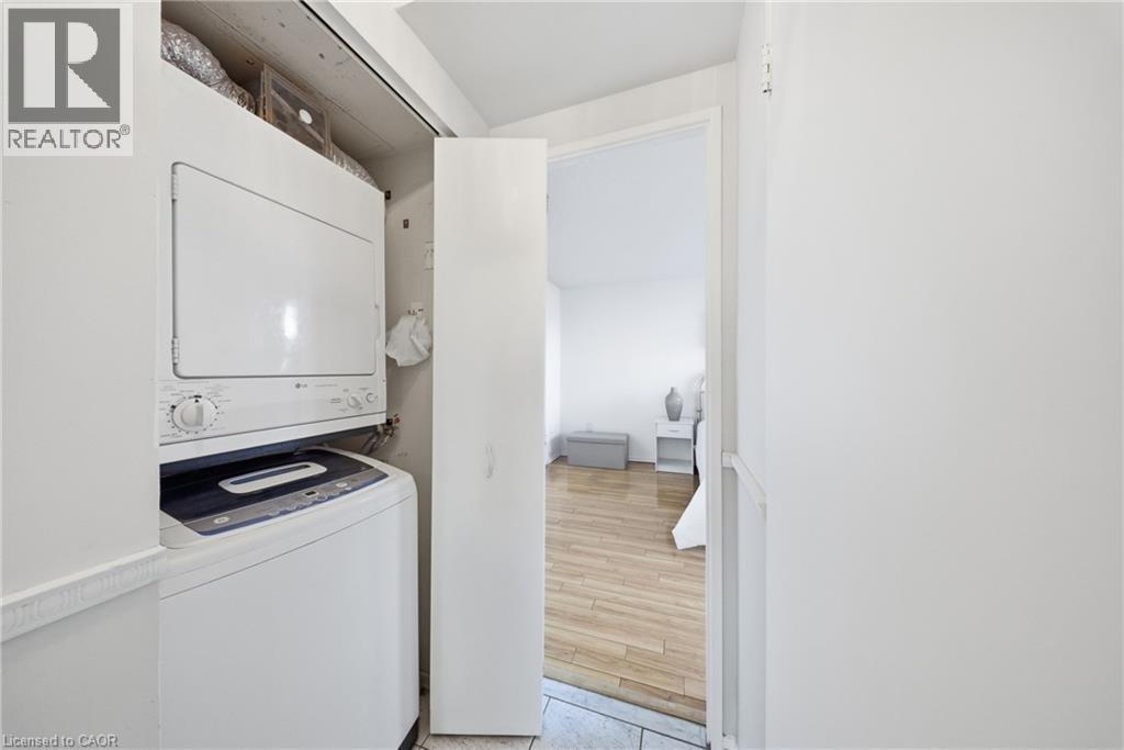 Dedicated laundry closet featuring a stackable washer and dryer unit - 2055 Upper Middle Road Unit# 602, Burlington, ON