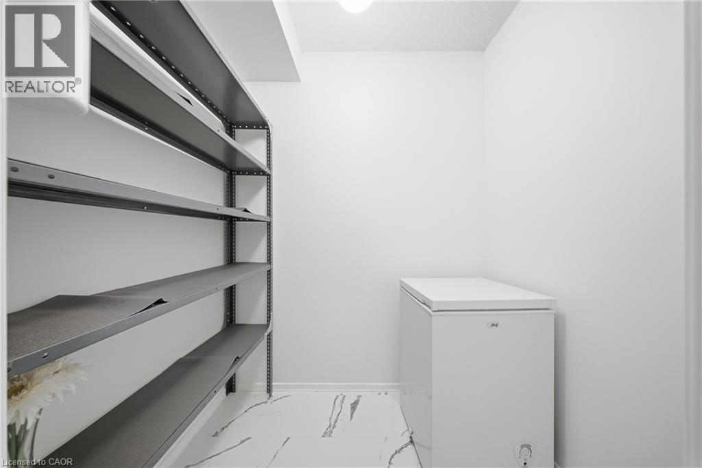 Utility area featuring light-toned walls and high-gloss flooring - 2055 Upper Middle Road Unit# 602, Burlington, ON