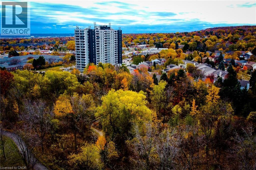 High-rise residential building featuring a dark facade with light-colored balconies - 2055 Upper Middle Road Unit# 602, Burlington, ON