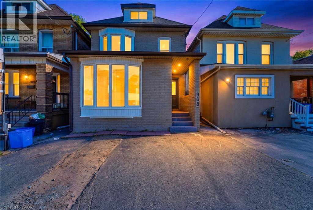 Brick exterior with a prominent bay window on the main level - 968 Main Street E, Hamilton, ON - Outdoor With Facade