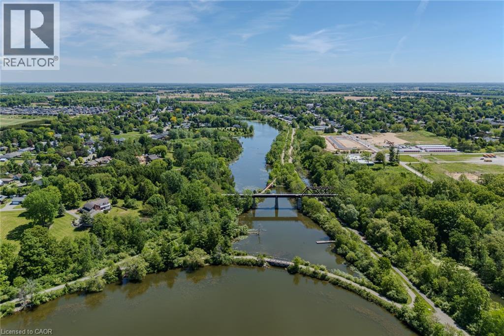 Aerial perspective featuring a river, surrounding green spaces, and a bridge - 15 Winterberry Lane, Waterford, ON