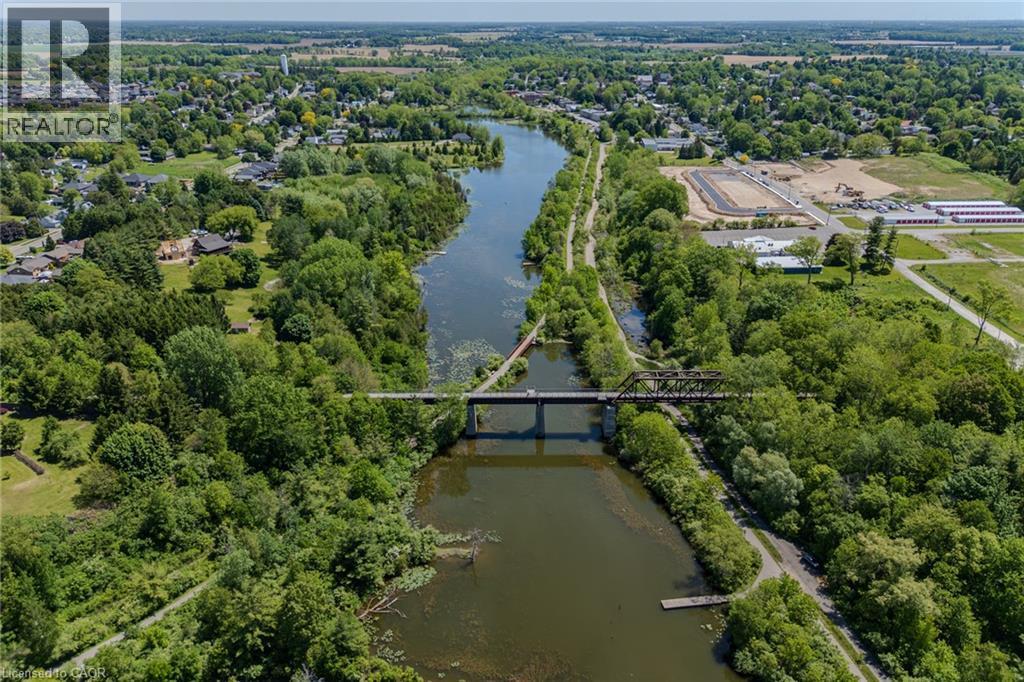 Expansive aerial perspective showcasing a river, bridge, and surrounding green spaces - 15 Winterberry Lane, Waterford, ON