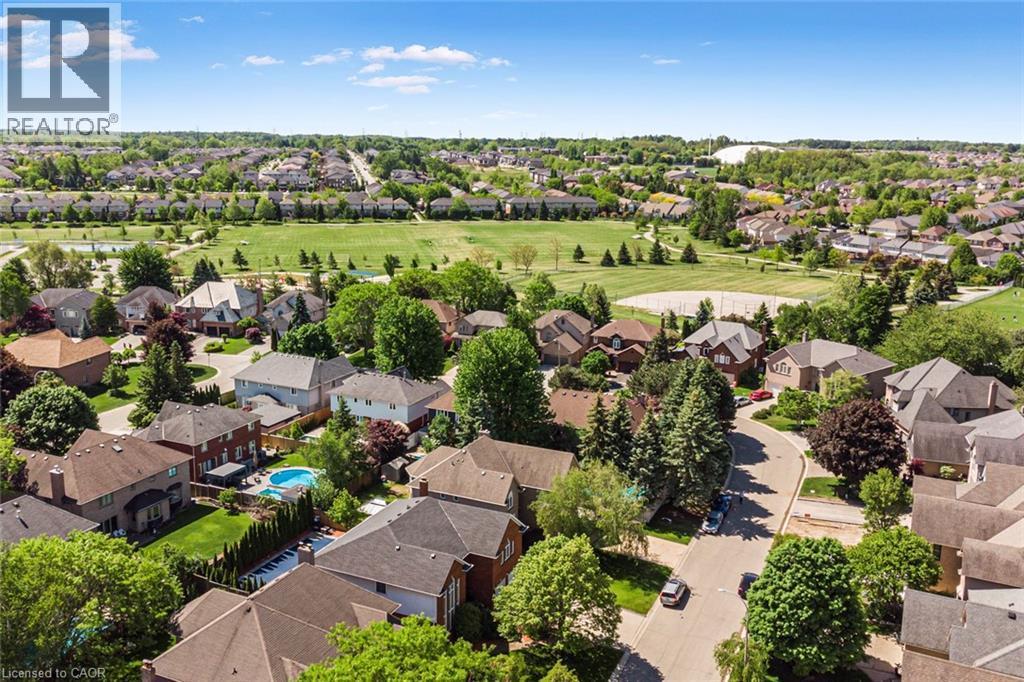 Aerial perspective showcasing a residential area with varied home styles and mature trees - 85 Citation Crescent, Ancaster, ON