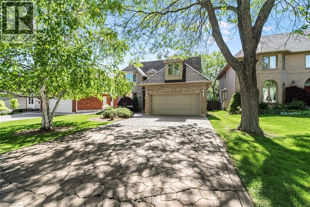 Two-story brick exterior with an attached two-car garage - 85 Citation Crescent, Ancaster, ON