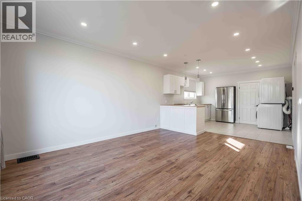 Open concept living area featuring wood-finish flooring - 204 Glow Avenue Unit# Upper, Hamilton, ON