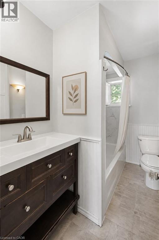 Bathroom with a dark wood vanity, white countertop, and brushed nickel fixtures - 149 Young Street, Kitchener, ON - Indoor Photo Showing Bathroom
