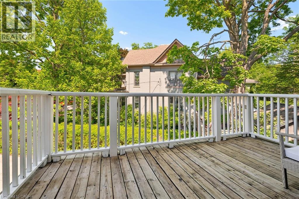 Spacious outdoor deck featuring natural wood planks and white balusters - 149 Young Street, Kitchener, ON - Outdoor With Deck Patio Veranda With Exterior