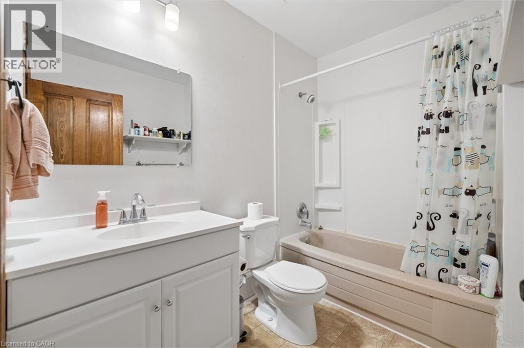 Bathroom featuring a single vanity with storage, an integrated sink, and a chrome faucet - 149 Young Street, Kitchener, ON - Indoor Photo Showing Bathroom