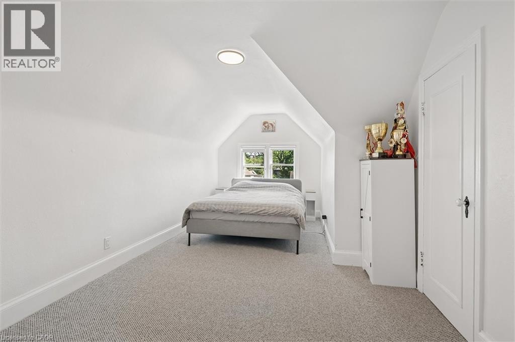 Attic space featuring sloped ceilings, a recessed window, and light-colored carpeting - 149 Young Street, Kitchener, ON - Indoor Photo Showing Bedroom