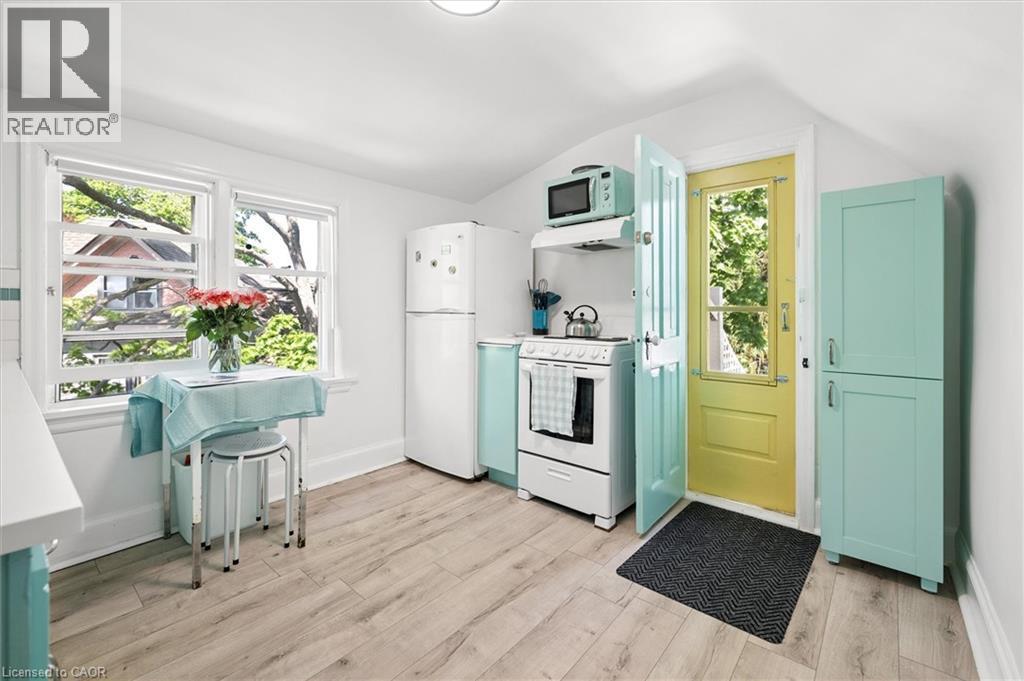Bright kitchen featuring wood-finish flooring and white walls - 149 Young Street, Kitchener, ON - Indoor Photo Showing Kitchen