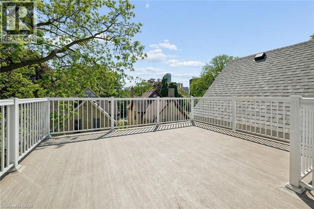 Expansive rooftop deck featuring a light-toned surface and white railing - 149 Young Street, Kitchener, ON - Outdoor With Exterior