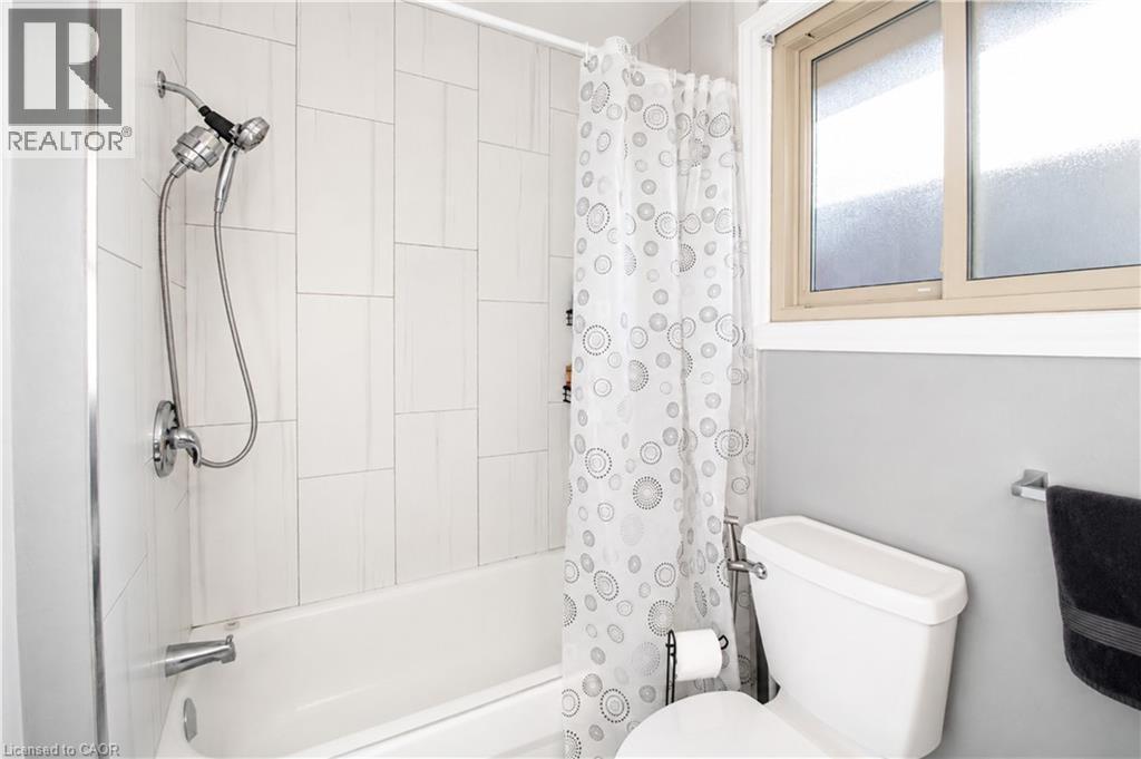 Full-size bathtub with subway tile surround and chrome fixtures - 103 Mcanulty Boulevard Unit# Upper, Hamilton, ON