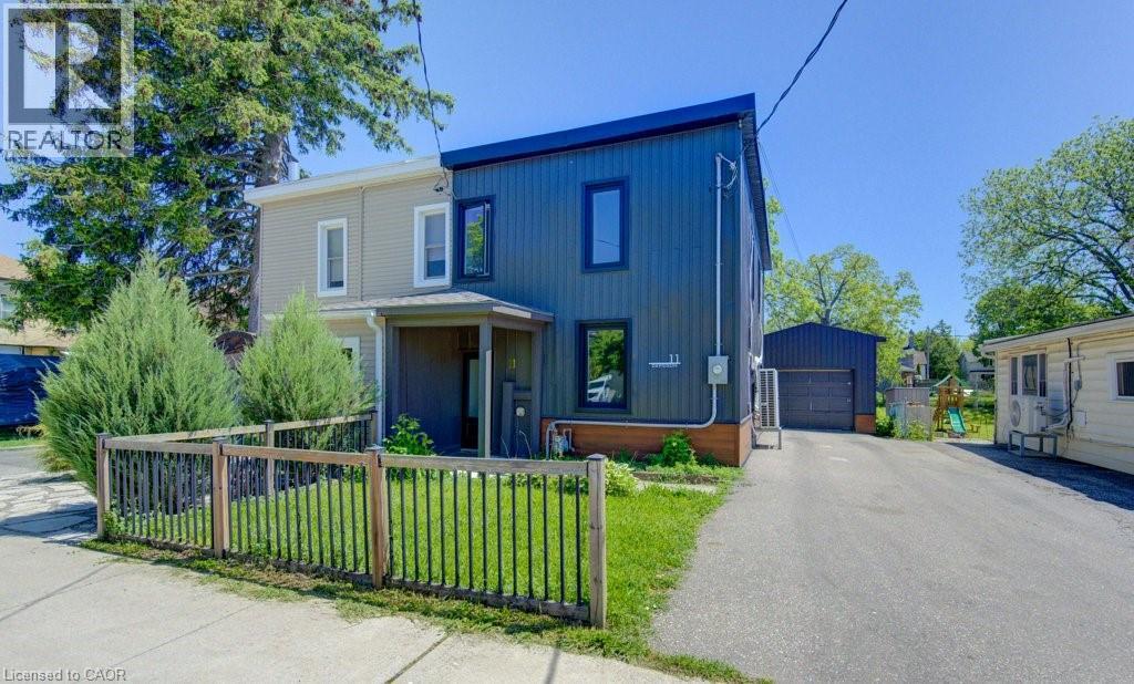 Contemporary facade featuring dark corrugated siding and black-framed windows - 11 Davidson Street, Cambridge, ON