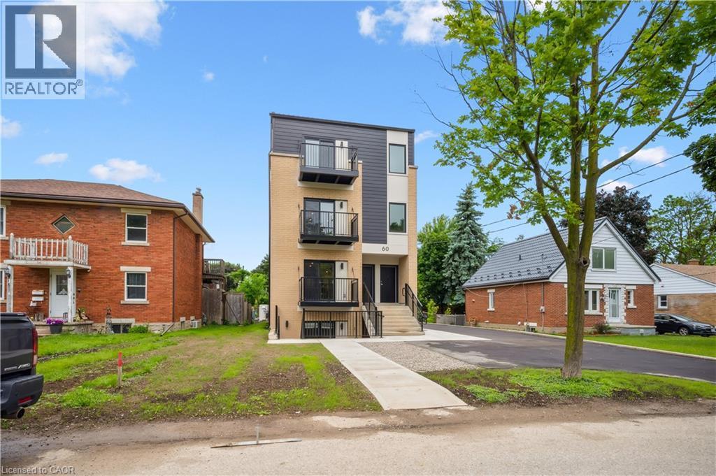 Modern multi-level building featuring a combination of brick and dark panel siding - 60 Arlington Boulevard Unit# 3, Kitchener, ON