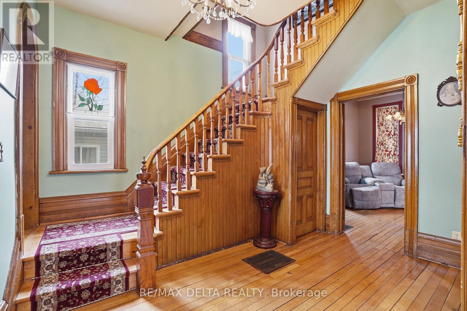 A beautiful staircase with a landing. - 132 High Street, Champlain, ON