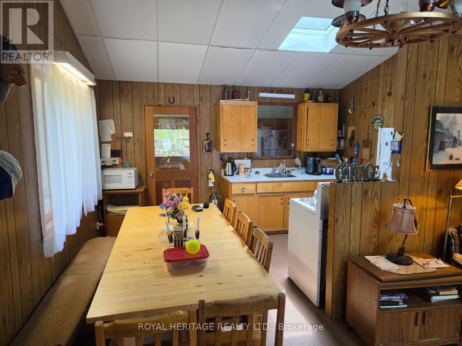 **Dining Room/Kitchen With Skylight** - 1160 Sunset Strip Lane, Frontenac, ON - Indoor Photo Showing Dining Room