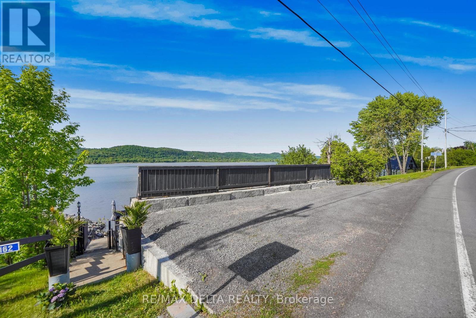 Stairs to lower levels beside parking area. - 162 Front Road W, Champlain, ON