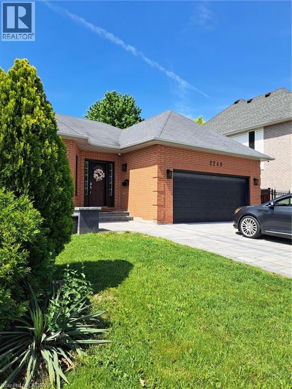 Brick exterior with a dark gray shingled roof - 2240 Headon Road Unit# Lower, Burlington, ON