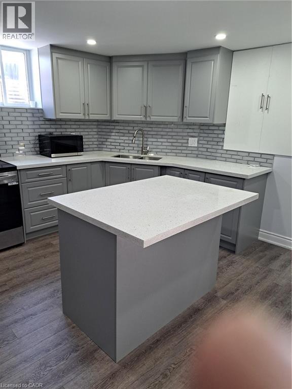 Kitchen island featuring a light-toned countertop - 2240 Headon Road Unit# Lower, Burlington, ON