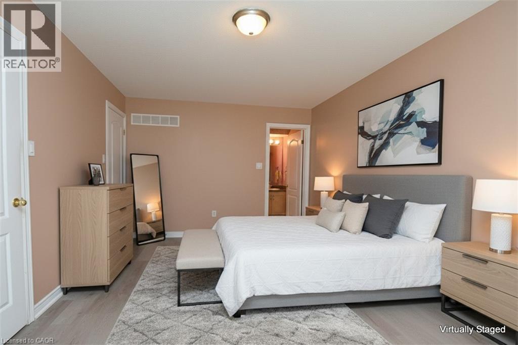 Expansive bedroom featuring light wood-finish flooring, neutral wall tones, a recessed ceiling light, and white trim throughout - 2 Harbour Drive Unit# 17, Stoney Creek, ON