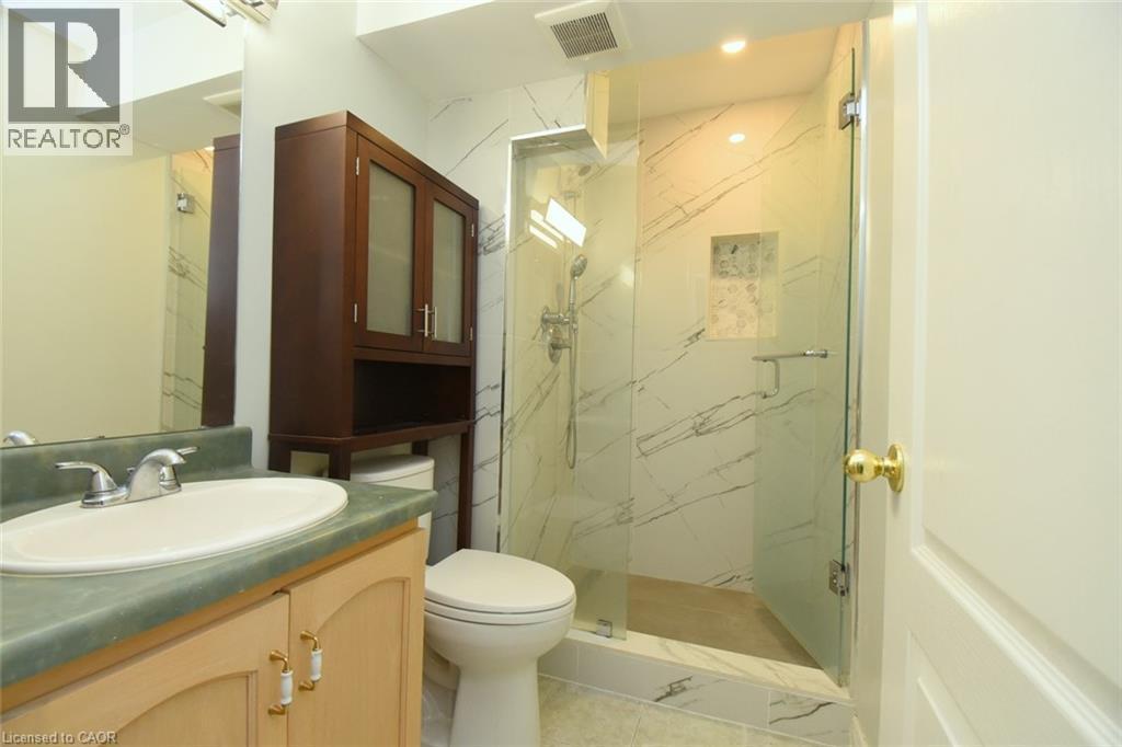 Glass-enclosed shower with a tiled surround featuring a built-in niche - 2 Harbour Drive Unit# 17, Stoney Creek, ON