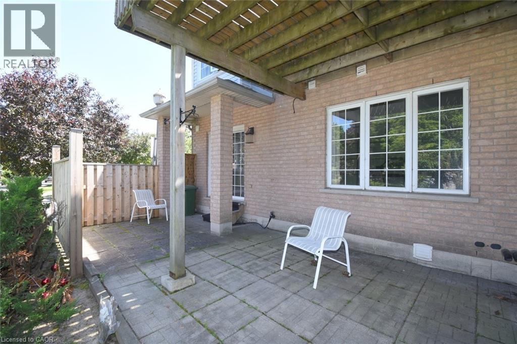 Brick exterior featuring a covered patio with concrete pavers - 2 Harbour Drive Unit# 17, Stoney Creek, ON