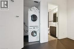 Dedicated laundry closet featuring a stacked washer and dryer -