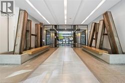 Modern entryway featuring a glass-paneled double door, concrete flooring, and built-in wood benches -