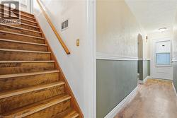 Stairs with wood finished floors and arched walkways -