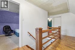 Hall featuring an upstairs landing and light wood-style flooring -