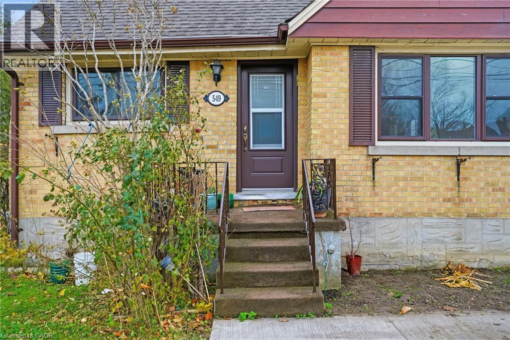 Doorway to property with roof with shingles and brick siding - 549 Weber Street E, Kitchener, ON