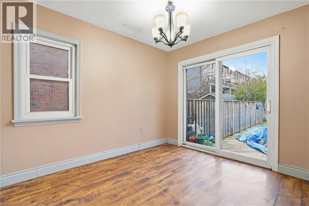 Dining room featuring wood finished floors, a chandelier, and a textured ceiling - 549 Weber Street E, Kitchener, ON