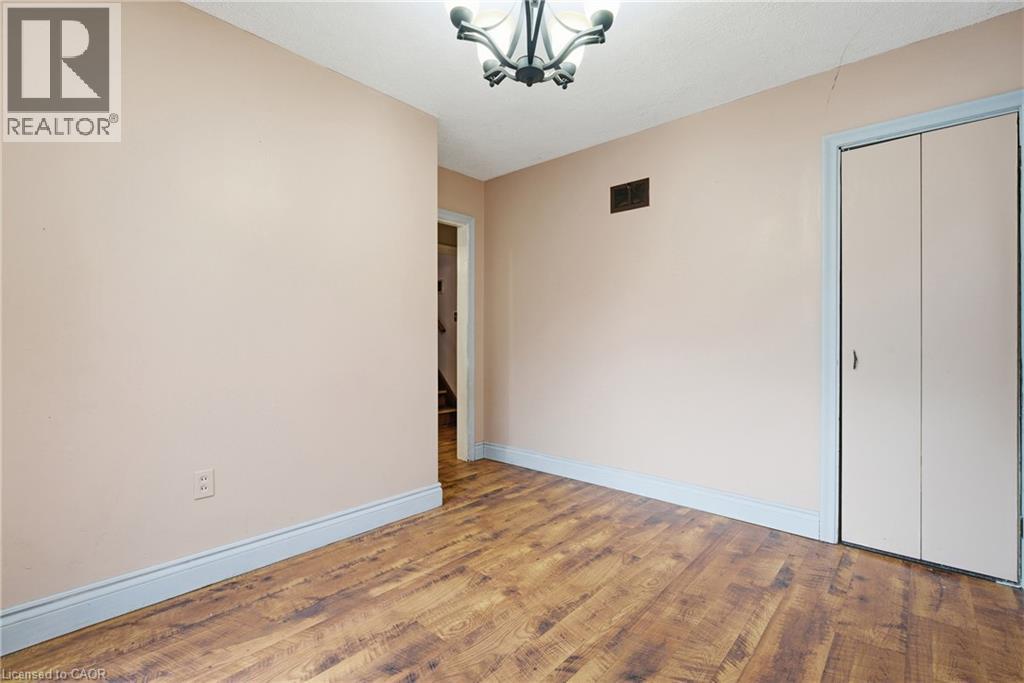 Dining room with wood finished floors, a chandelier, and a closet - 549 Weber Street E, Kitchener, ON