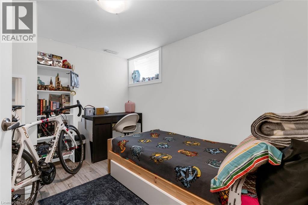 Recessed window with white trim, light wood-finish flooring, built-in shelving, and a flush-mount ceiling light fixture - 406 East 43Rd Street, Hamilton, ON