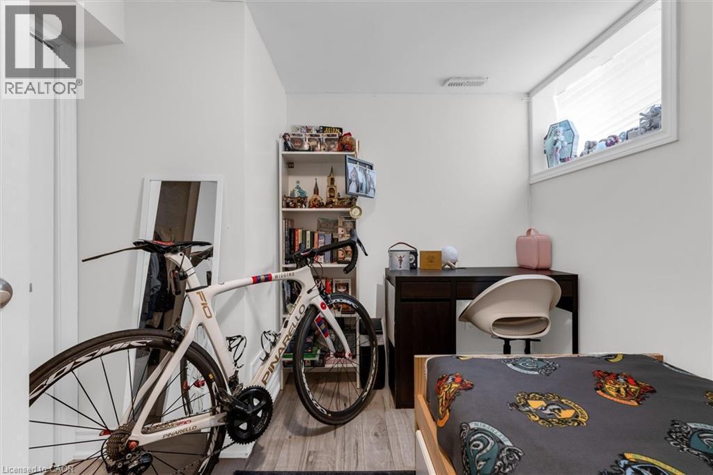 Interior room featuring light wood-finish flooring, white walls, and a built-in window with white trim - 406 East 43Rd Street, Hamilton, ON