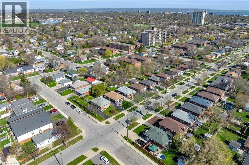 Aerial perspective of a residential neighborhood featuring detached homes with mature trees and manicured lawns - 406 East 43Rd Street, Hamilton, ON