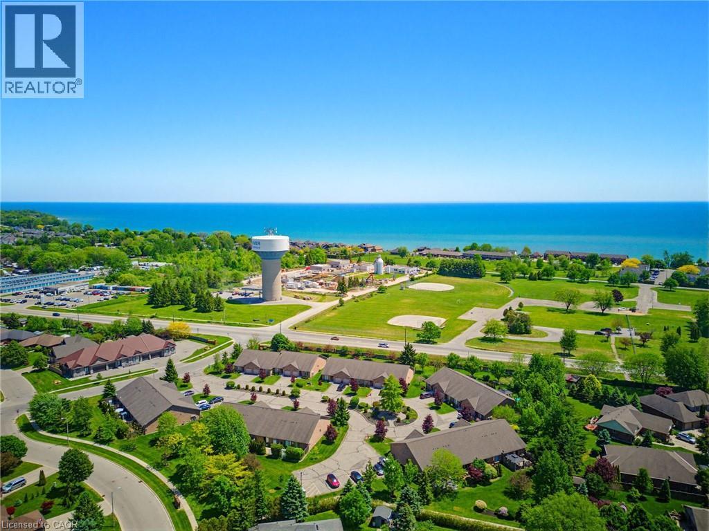 Aerial perspective showcasing extensive water frontage, surrounding green spaces, and community infrastructure - 5 Coastal Court, Port Dover, ON