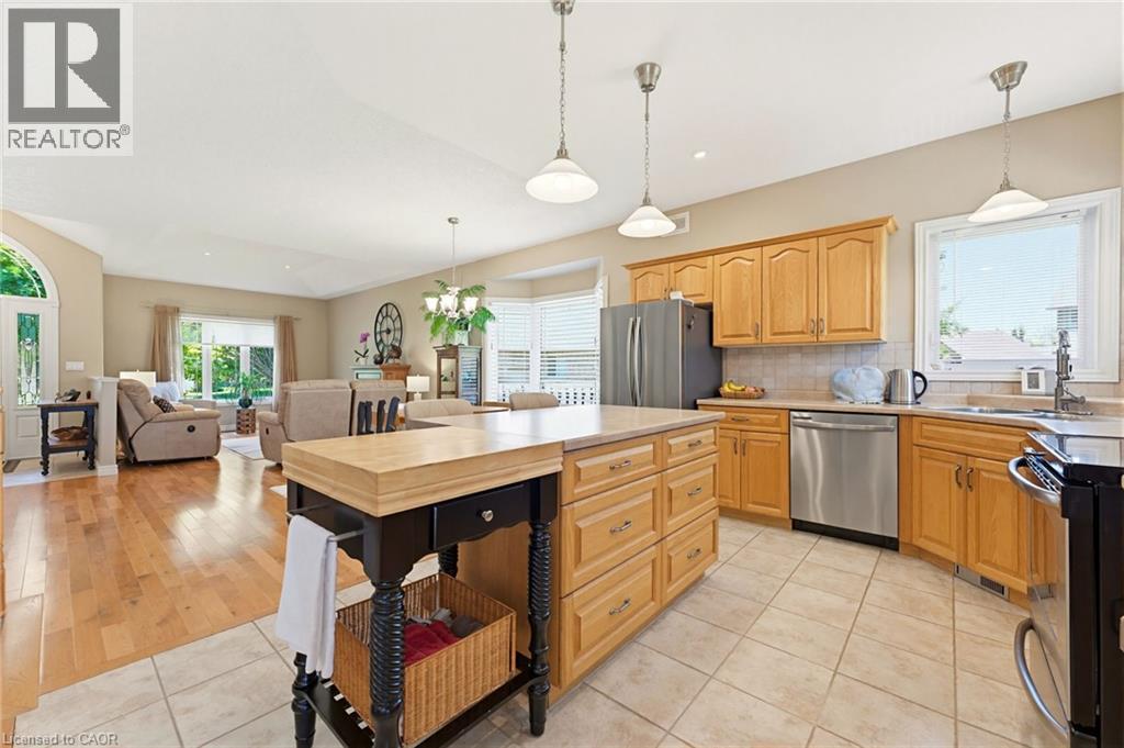 Kitchen featuring wood cabinetry, stainless steel appliances, and a tiled floor - 5 Coastal Court, Port Dover, ON