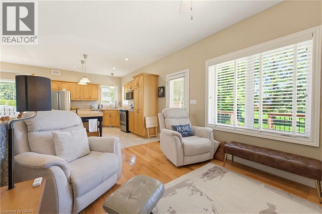 Open-concept living space with wood-finish flooring - 5 Coastal Court, Port Dover, ON