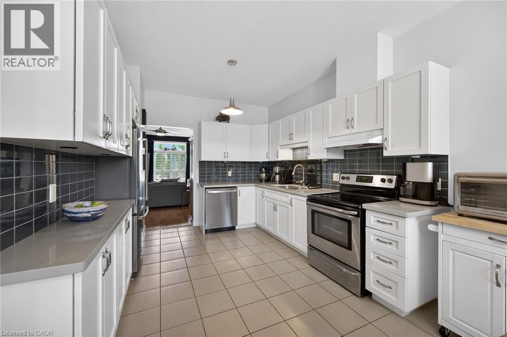 Spacious and timeless classic white kitchen featuring quartz countertops - 6 Gaddye Lane, Binbrook, ON - Indoor Photo Showing Kitchen
